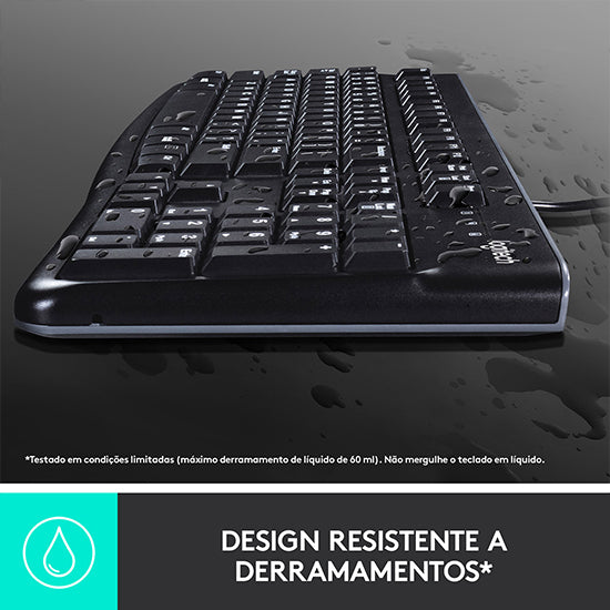 Black Logitech keyboard with water droplets on a dark surface.