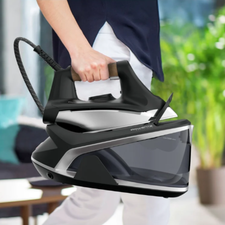 Rowenta Easy Steam iron with boiler, black, 2400W, held by a person.