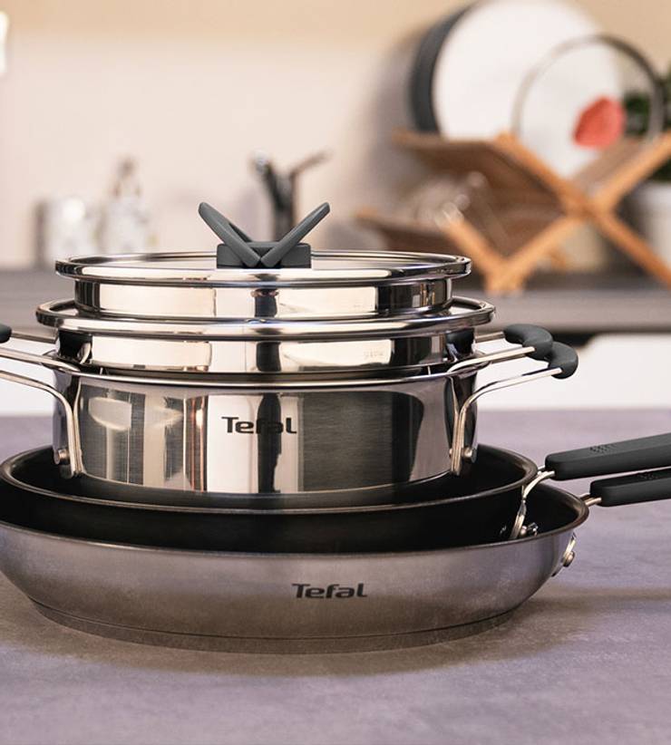Tefal stainless steel cookware set with 3 pieces and glass lids, silver and black handles.