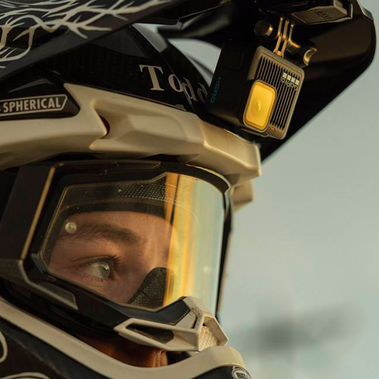 GoPro Hero action camera on a black and white helmet.