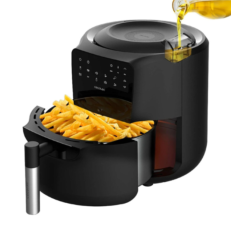Black Cecotec air fryer with basket full of fries and oil being poured.