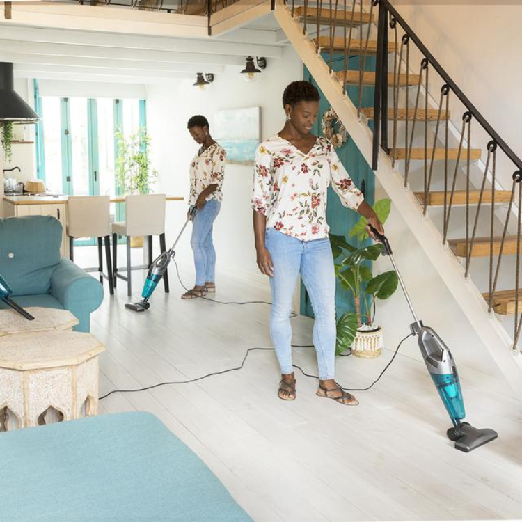 Cecotet Conga Popstar 1000 Duostick vacuum cleaners, teal and grey, with two women using them on white wooden floor.