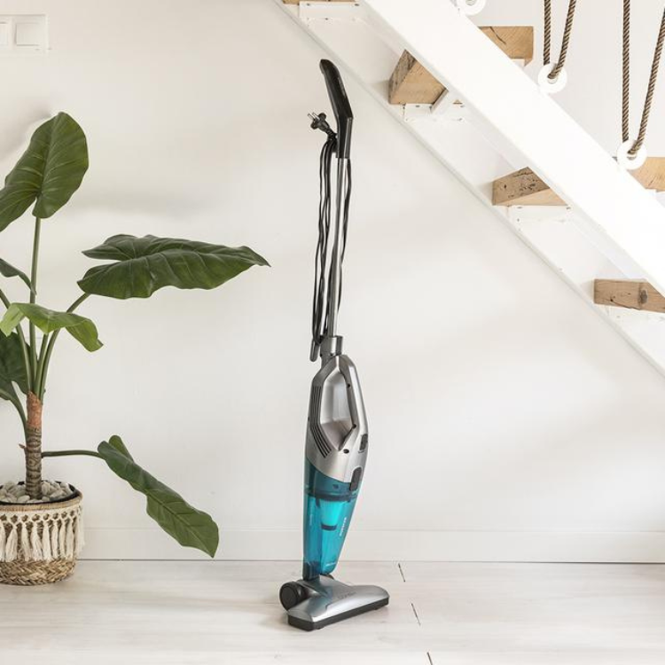 Cecotet Conga Popstar 1000 Duostick vacuum, silver and teal, standing upright on light floor.