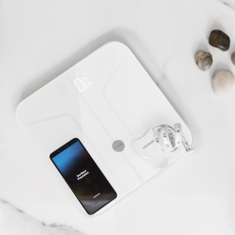 White Cecotec Surface Precision 970 smart scale with smartphone.