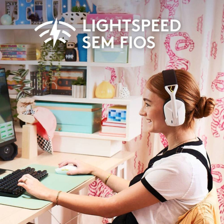Woman wearing white Logitech gaming headset and using white Logitech mouse.