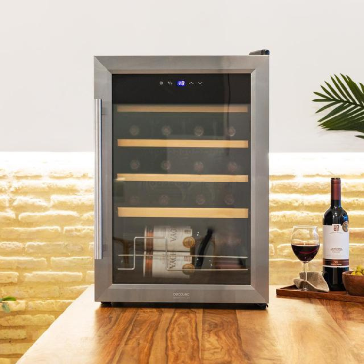 Cecotec Bolero GrandSommelier 2050 wine cooler, stainless steel, glass door, digital display, 5 wooden shelves, on wooden countertop with wine bottle and glass.