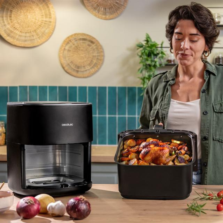 Black Cecotec air fryer and grill with food basket on kitchen counter.