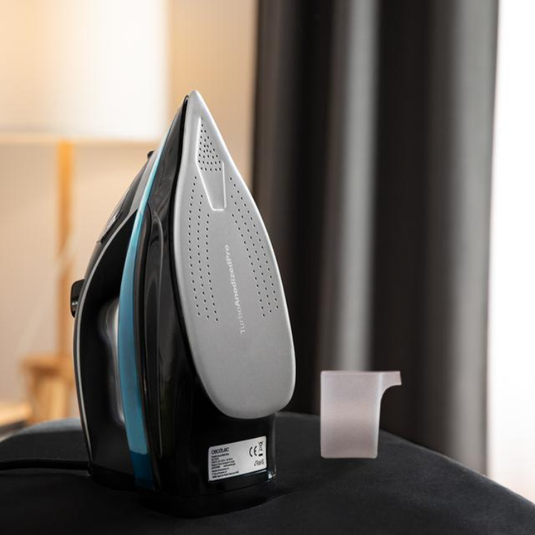 Cecotec Fast&Furious 6060 Ultra steam iron, black and blue, 3100W, on ironing board.