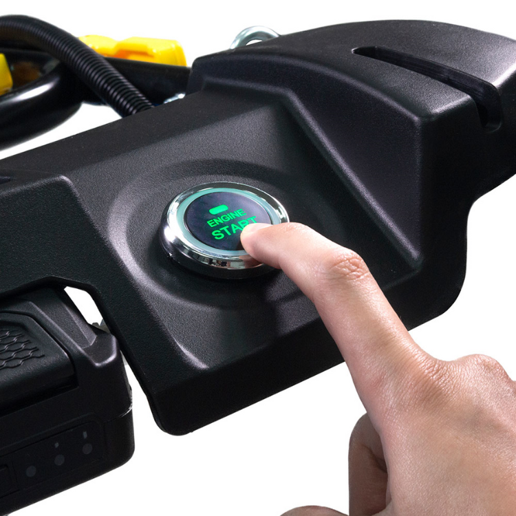 Black lawn mower start button with green text, finger pressing button. Goodyear branding.