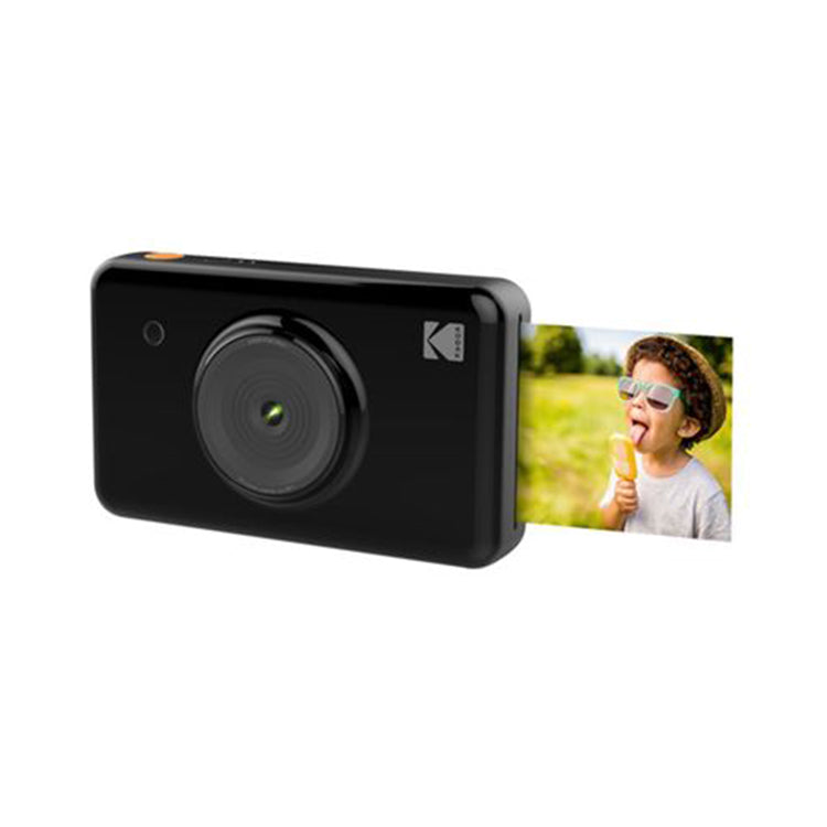 Black Kodak instant camera with photo ejecting, showing a child with ice cream.