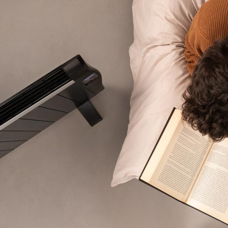 Black Cecotec Ready Warm 2500 Thermal heater, 1800W, on floor next to bed.