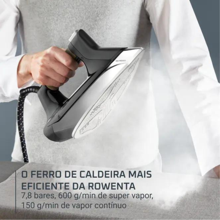 Black Rowenta steam iron with white soleplate, held by a person.