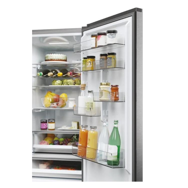 Haier fridge interior with food and drinks on shelves, silver finish.