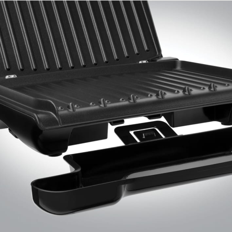 George Foreman electric grill, black, compact, open with tray extended.