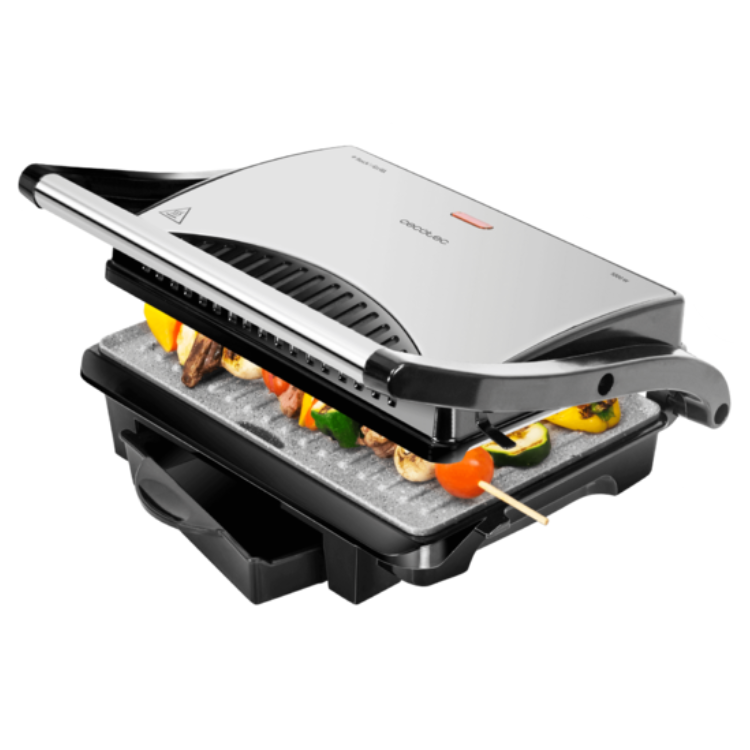 Cecotec Rockn Grill 1000W electric grill with open lid, showing vegetables and meat on skewer. Silver and black.
