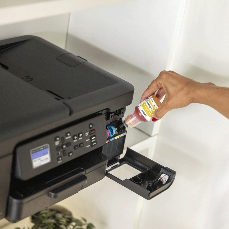 Black Brother DCP-T780DW inkjet printer with open ink tank, hand refilling magenta ink.