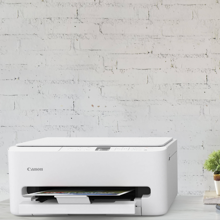 Canon PIXMA TS6550i white inkjet multifunction printer on a table.