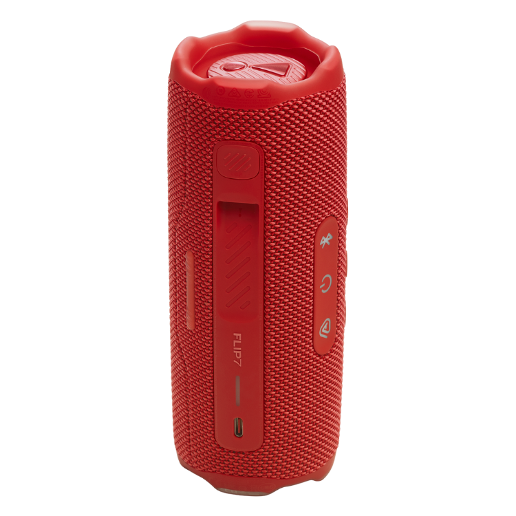 Red JBL Flip 7 portable speaker with textured surface and control buttons.