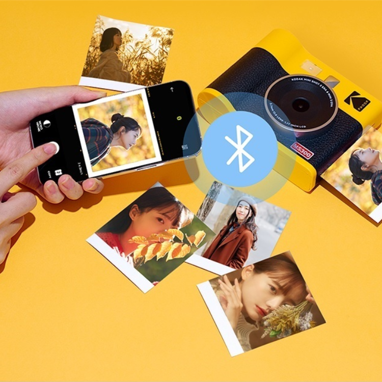 Yellow Kodak instant camera, black and yellow, with Bluetooth symbol and photos.