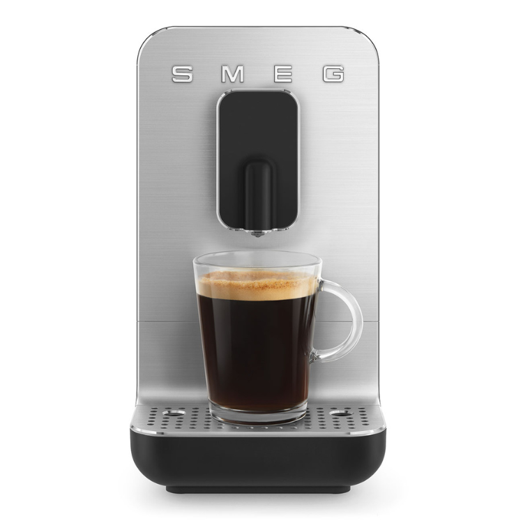 SMEG automatic coffee machine, silver and black, with a cup of coffee.