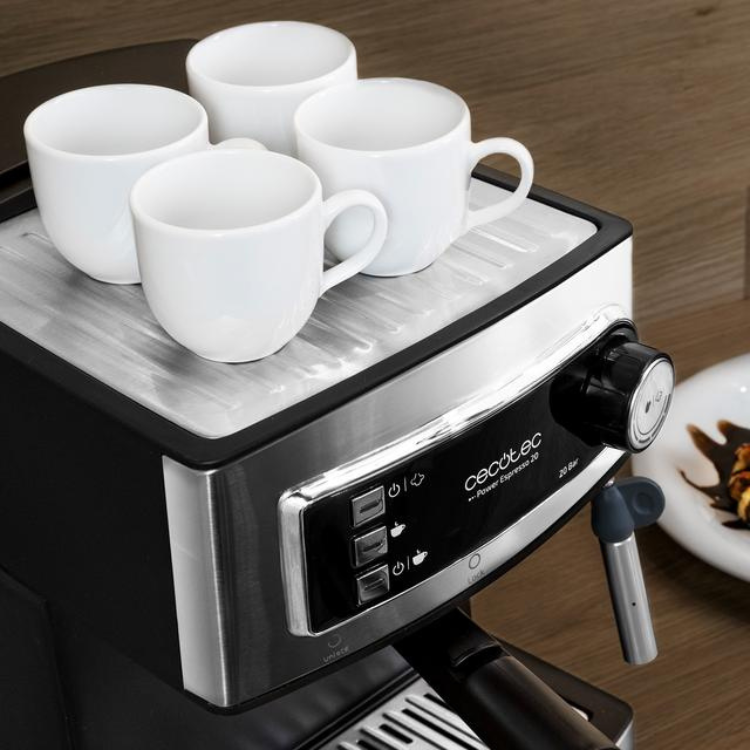 Cecotec Power Espresso 20 Professionale coffee machine, black and silver, with four white cups on top.