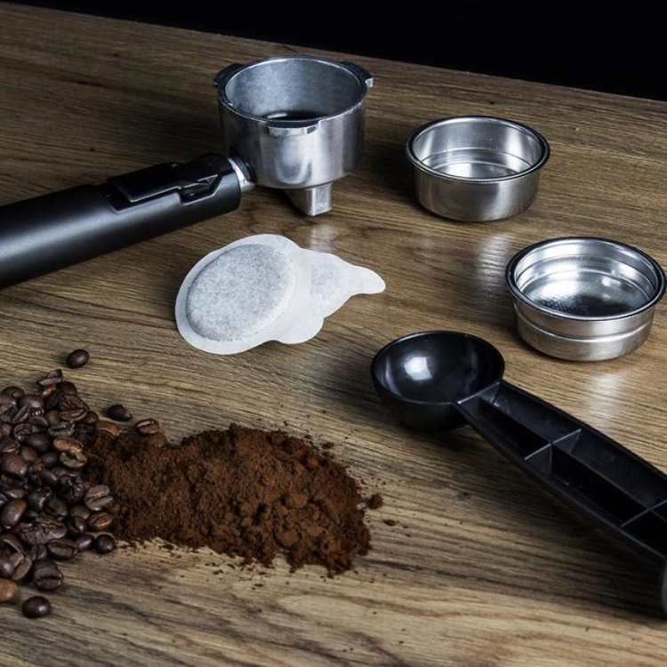 Cecotec Power Espresso 20 Professionale coffee machine accessories, black and silver, with coffee beans and grounds.