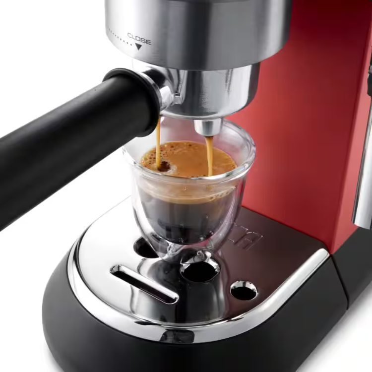 Red De'Longhi manual espresso machine dispensing coffee into glass cup.