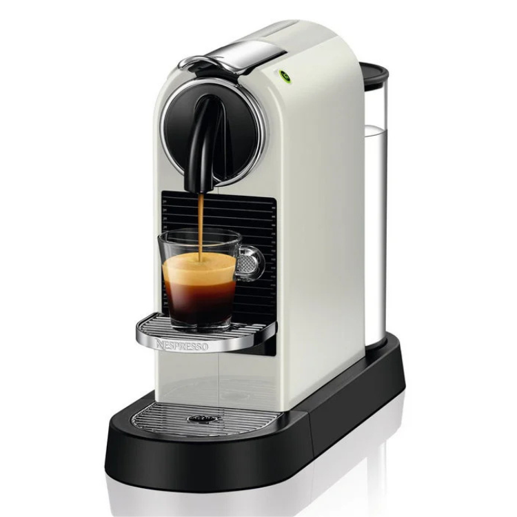 White Nespresso Citiz coffee machine with black base, dispensing espresso into a glass cup.