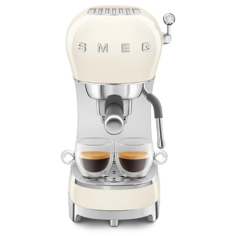 SMEG manual espresso machine in cream color with two cups of coffee.