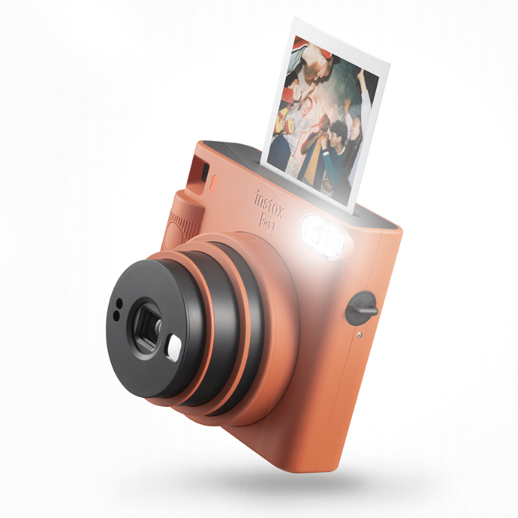 Fujifilm Instax SQ1 orange instant camera with photo ejecting.