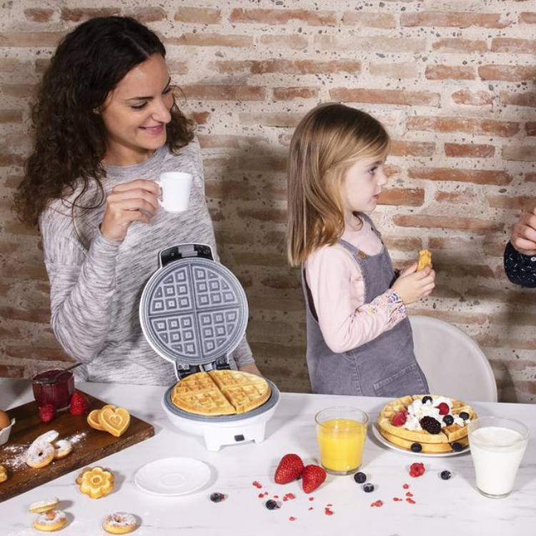 Woman and child with waffle maker and food on table, Cecotec Fun Gofrestone 3in1 waffle machine.