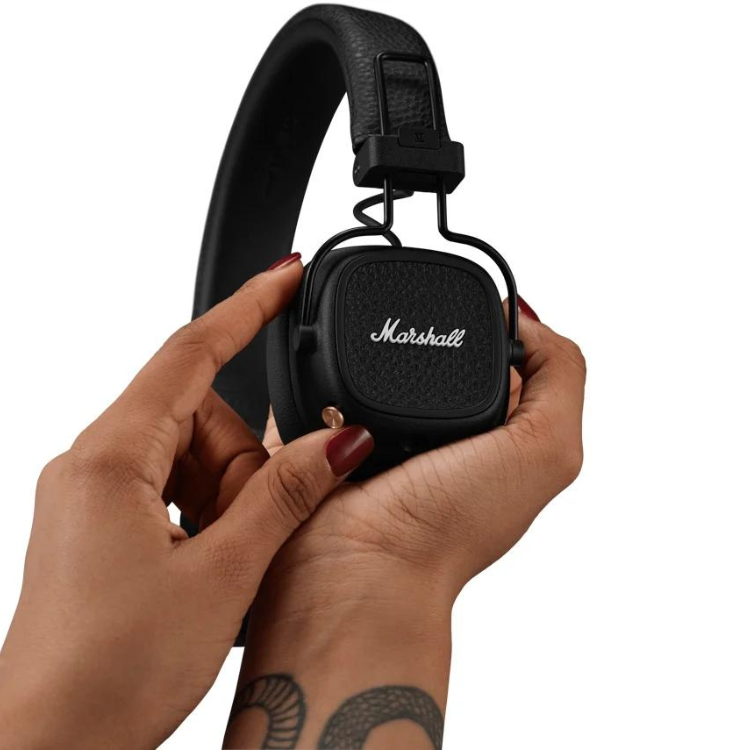 Black Marshall Major V on-ear headphones held in two hands.
