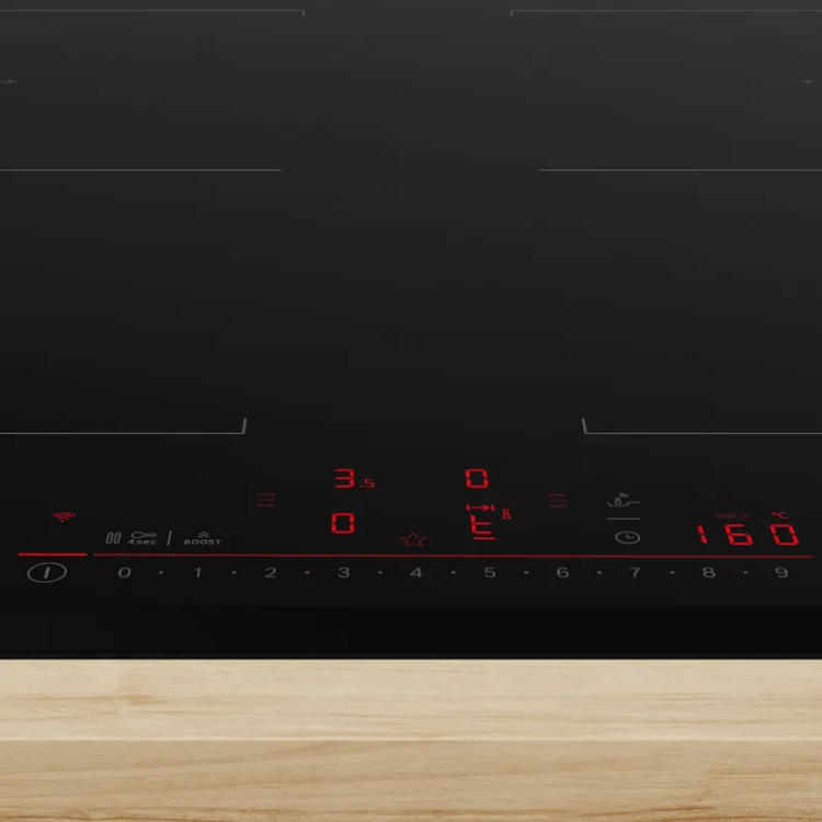 Black Bosch induction cooktop with red display and 4 zones on wooden countertop.