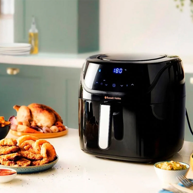 Black Russell Hobbs air fryer with digital display and food plates around.