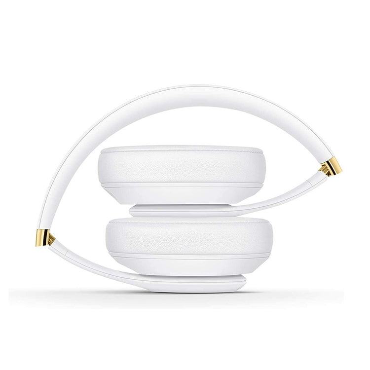 White Beats Studio 3 headphones with gold accents.