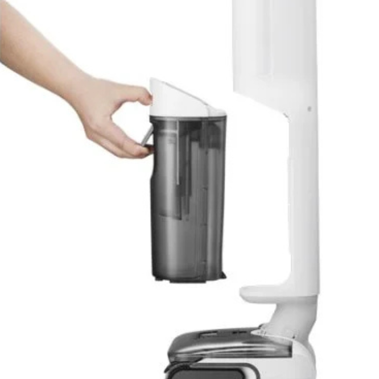 White Roborock F25 RT vacuum with transparent dustbin and hand removing it.