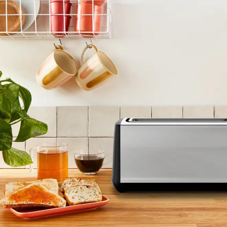 Moulinex Subito Select toaster, 2 slots, silver and black, on wooden countertop with toast and drinks.