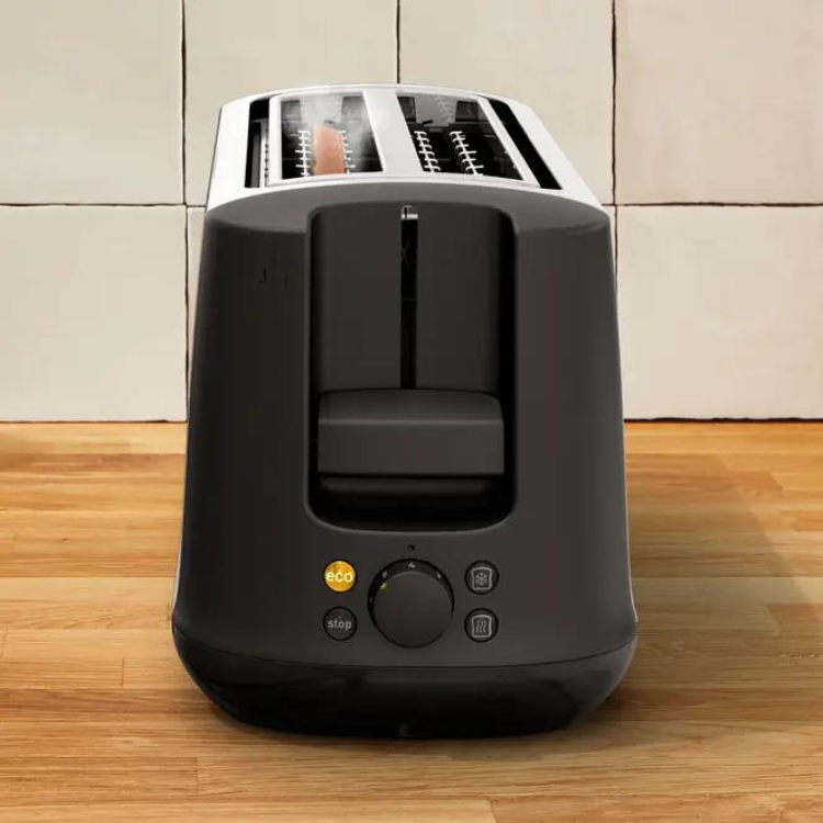 Black and silver Moulinex toaster with 2 slots and control dial on wooden surface.