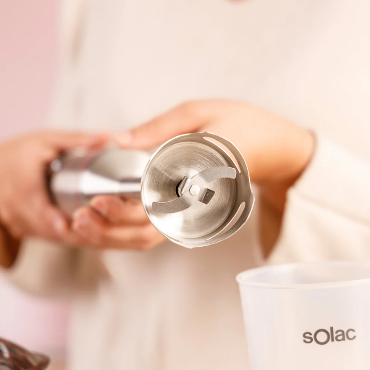 Stainless steel blender part, Solac Pro Chef 1501, held by hands.