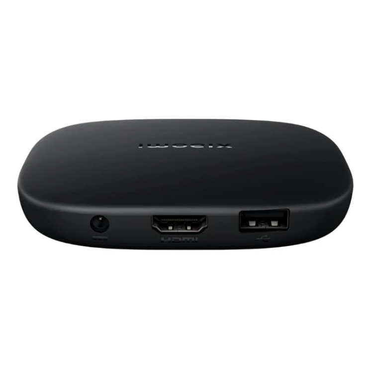 Black Xiaomi TV Box S, oval-shaped streaming device with ports.